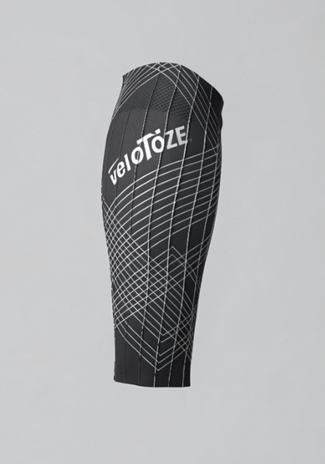 Black cycling calf sleeve with geometric white pattern and visible veloToze logo
